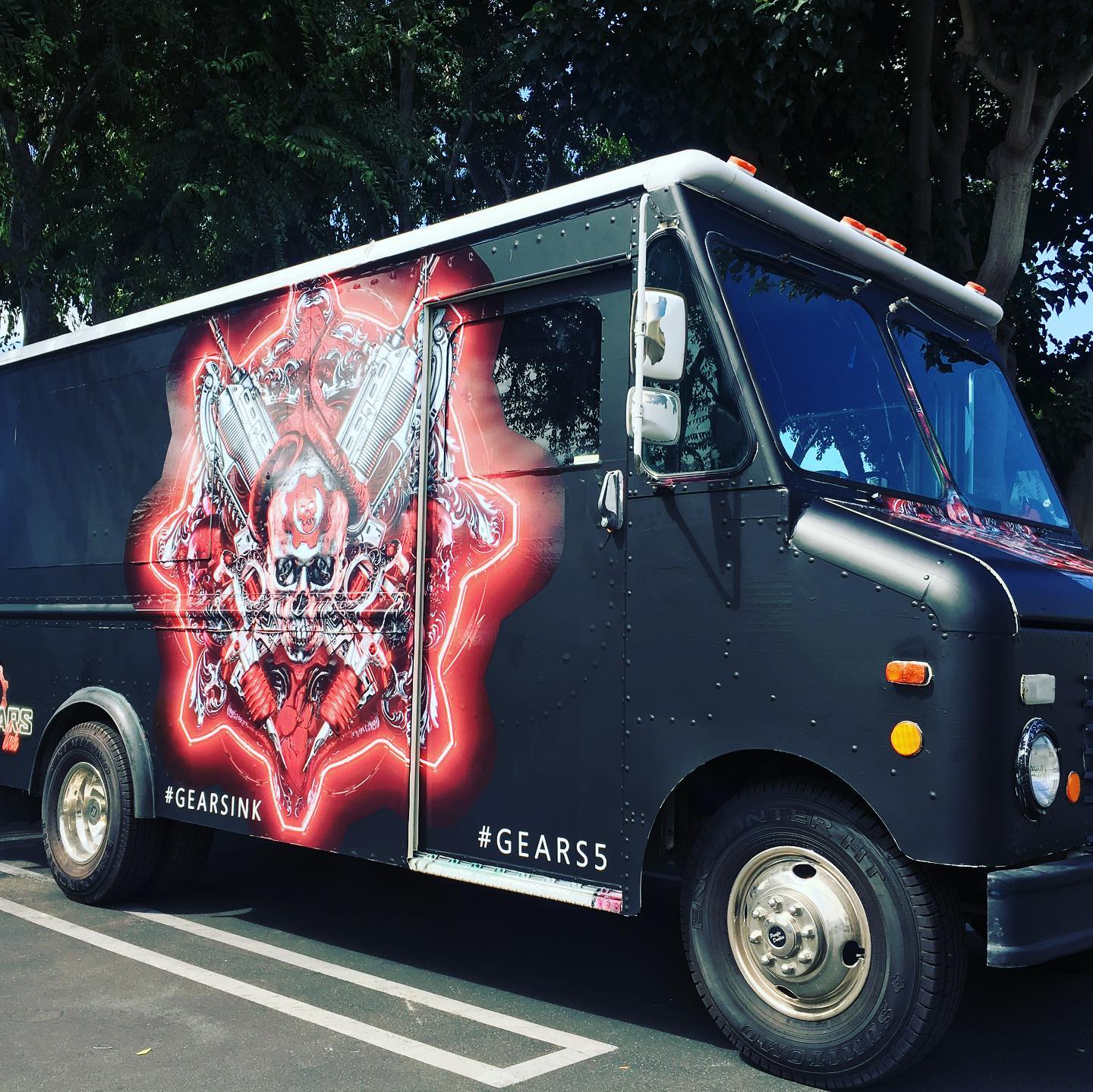 Black step van food truck with "gears of war 5" wrap design for an Xbox event at the container yard in Los Angeles, California.
